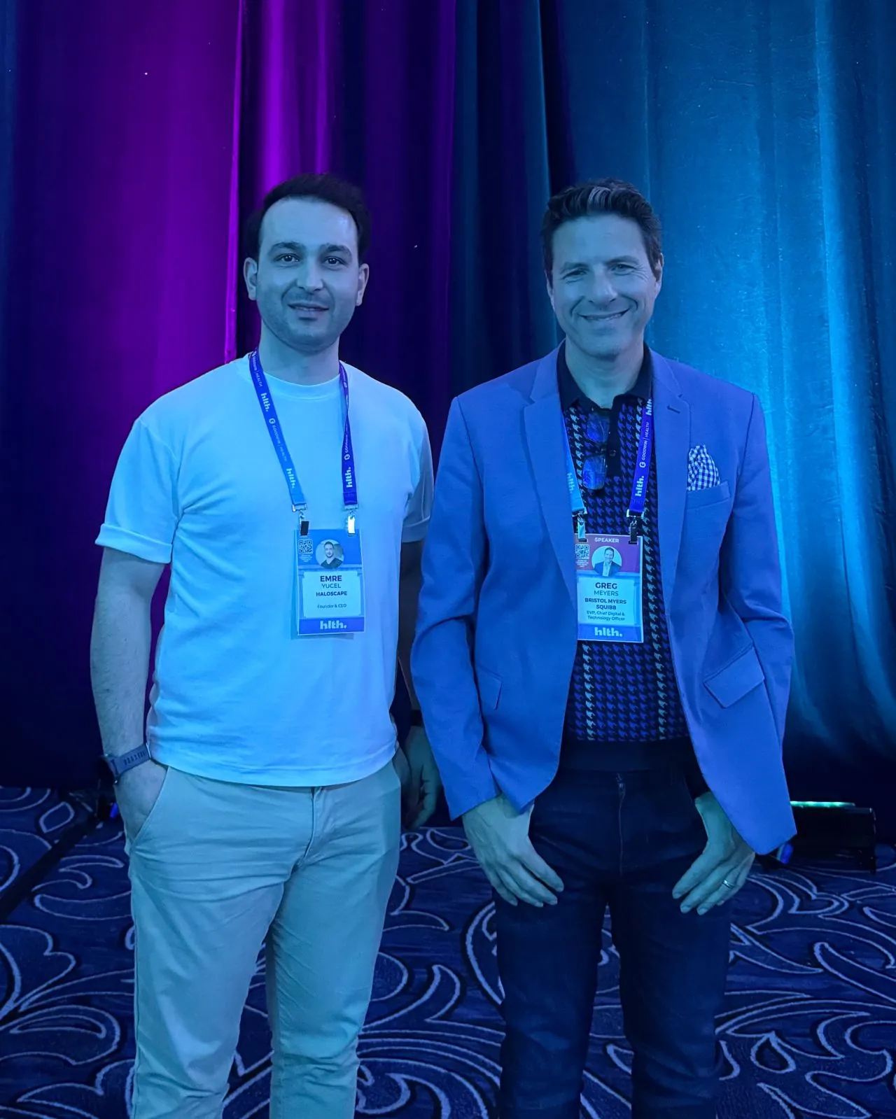 Emre Yücel with Greg Meyers of Bristol Myers Squibb, and the HLTH USA main stage in Las Vegas.